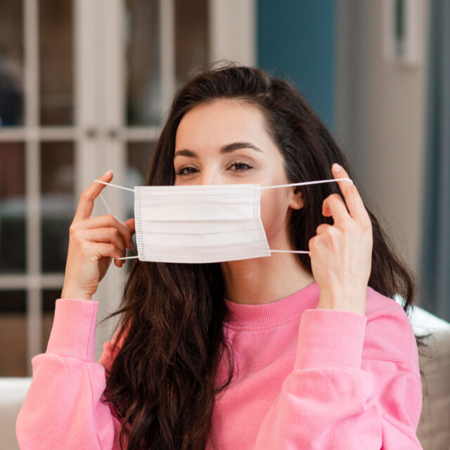 young blogger putting surgical mask