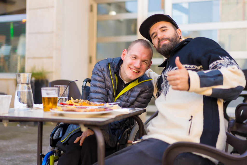 selfie portrait friends eating restaurant terrace disabled person eating